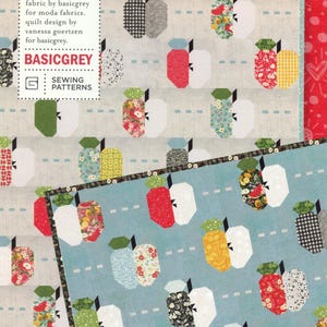 May include: A quilt pattern titled "Apple Dandy" featuring a repeating apple design in various colors and patterns. The pattern includes text that reads "PATO68" and "BASICGREY". The design is by Vanessa Goertzen for Basicgrey.