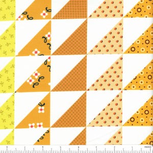 May include: A fabric pattern featuring a grid of white and colored triangles. The triangles display various yellow and orange prints, including small white flowers, dark brown dots, and concentric circles, with a ruler showing 9 inches.