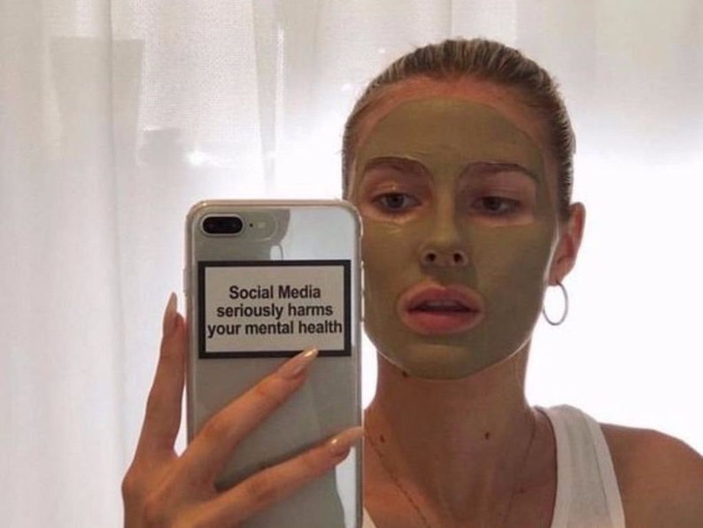 May include: A white phone case with a black and white sticker that reads "Social Media seriously harms your mental health".