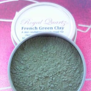 May include: A round metal tin with a green powder inside. The label on the tin reads "Royal Quartz French Green Clay. A skin revitalizing and good for clear..."