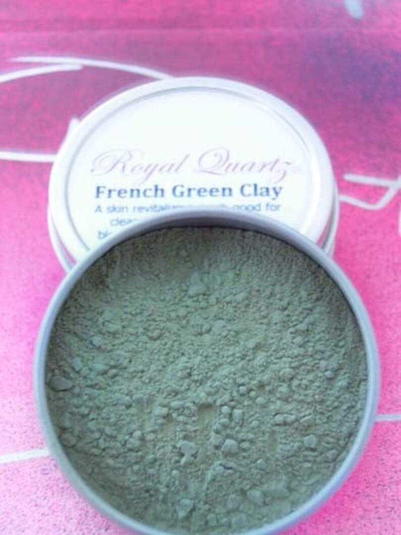May include: A round metal tin with a green powder inside. The label on the tin reads "Royal Quartz French Green Clay. A skin revitalizing and good for clear..."