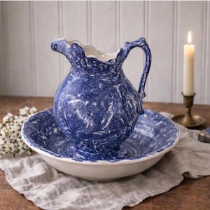 May include: A set of three ceramic mugs with a speckled, matte finish. The mugs are in shades of cream, light gray, and dark gray. Each mug has a simple, minimalist design, perfect for coffee or tea.