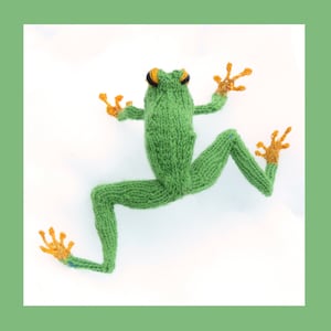 May include: A handmade knitted frog in bright green with orange feet and hands. The frog has black and yellow eyes and is posed as if jumping. The background is white, with a green border.