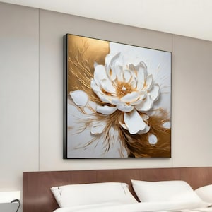May include: A white flower with a textured, 3D effect, set against a gold background. The flower is the focal point of the artwork, with its petals and center highlighted in white. The gold background adds a touch of luxury and elegance to the piece.