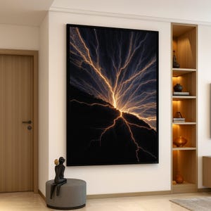 May include: Large framed artwork featuring a digital depiction of a lightning storm. The image showcases a dark, mountainous landscape with vibrant golden lightning bolts radiating across the sky. The artwork is displayed on a white wall.