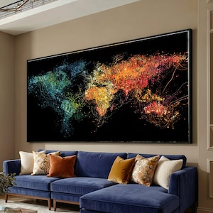 May include: Large framed artwork featuring a colorful world map design against a black background. The map is rendered with vibrant hues of blue, green, yellow, orange, and red, creating a striking visual effect. The artwork is displayed above a blue sectional sofa.