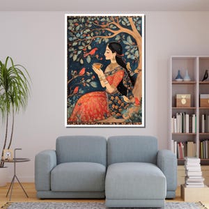 May include: A woman in a red and blue dress sits under a tree with birds. She is holding a cup and looking at the birds. The painting is done in a traditional Indian style.