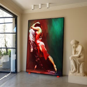 May include: Large framed artwork depicting a couple dancing the tango. The painting features a man in dark clothing and a woman in a red dress. The background transitions from red to green. The artwork is displayed in a room with a statue.
