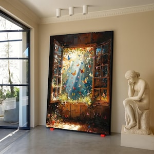May include: A large framed artwork shows an open window scene with butterflies and sunlight. The painting uses blues, greens, and yellows. The artwork is propped up on orange supports in a well-lit room. The artwork is a decorative piece.