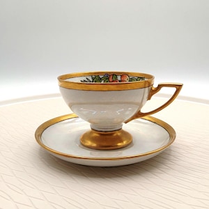 Hutschenreuther Selb Bavaria fruit motif iridescent tea cup and saucer.