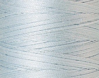 May include: A spool of light blue Mettler Silk-Finish thread. The spool has a light purple top and bottom with the brand name and thread details printed on it. The thread is No. 50 and contains 500m/547 yds.