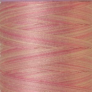 May include: A spool of pink and cream colored thread with the text "GROUP Mettler SILK-FINIS" on the top and "on merc. No.50 457m/500yds" on the bottom.