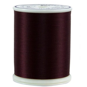 May include: A spool of dark brown thread.