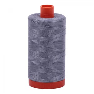 May include: A spool of gray thread with a red top and bottom. The thread is tightly wound around the spool, creating a cylindrical shape. The thread appears to be a medium weight, suitable for various sewing projects.
