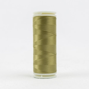 May include: A spool of olive green thread with white plastic bobbins.