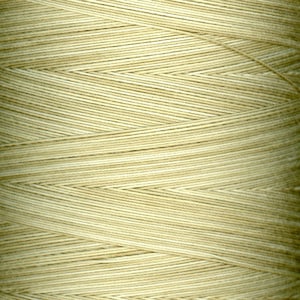 May include: A close-up of a spool of beige thread. The thread is wound tightly and has a smooth, even texture.