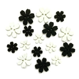 May include: A collection of flower-shaped buttons in black and white. The buttons have a two-hole design and are arranged on a white background. These decorative buttons are ideal for sewing and craft projects.