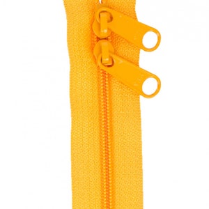 May include: A bright yellow zipper with two pull tabs. The zipper is open and the teeth are visible.