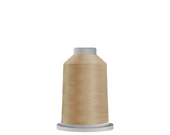 May include: A spool of beige thread for sewing or embroidery.