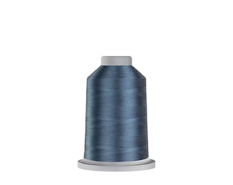 May include: A spool of blue thread for sewing or embroidery.