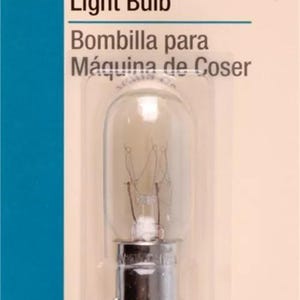 May include: A clear glass sewing machine light bulb with a silver metal base. The packaging is white with black text that reads "Sewing Machine Light Bulb" and "Bombilla para Máquina de Coser". The text "Push-in Bulb" and "Bombilla de Inserción" is also on the packaging.