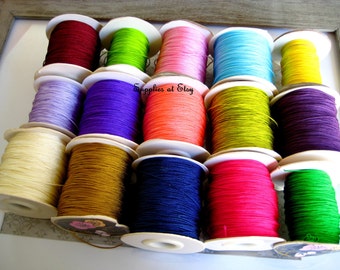 May include: Assortment of spools of colorful waxed cord, perfect for jewelry making, macrame, and crafts. The spools are arranged in three rows of four, with a variety of colors including red, green, pink, blue, yellow, purple, orange, brown, navy, and pink.