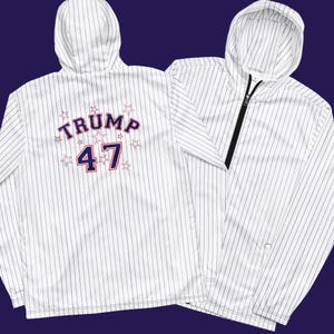 May include: White hooded sweatshirt with blue and white stripes. The back of the sweatshirt has a blue and white graphic that says "TRUMP 47" with stars.