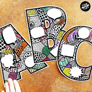 May include: Colorful ABC letters with speech bubbles, each letter featuring a unique black and white doodle design with accents of orange, yellow, green, purple, and pink. The letters are on a textured brown surface. The words "rise over run" are in the top right corner.