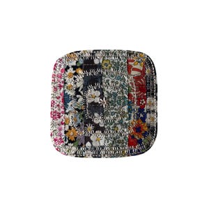 May include: Square coaster with a patchwork design. The coaster features a variety of floral fabric patterns in shades of pink, blue, yellow, and red. The edges are finished with a silver metallic trim.