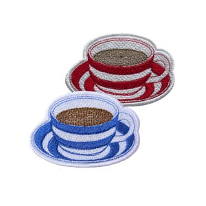 May include: Two embroidered patches of coffee cups on saucers. One cup is red and white striped, the other is blue and white striped. Both cups are filled with brown coffee and have white trim.