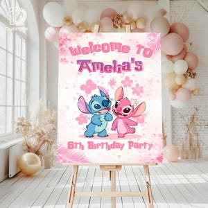 May include: A pink and white birthday party welcome sign featuring the characters Stitch and Angel. The sign reads "Welcome to Amelia's 6th Birthday Party" with floral and leaf accents. The sign is displayed on a wooden easel.