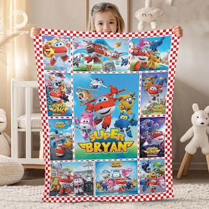 May include: A colorful blanket featuring characters from the animated series "Super Wings." The blanket has a red and white checkered border. The center panel displays the text "Super Bryan" with various cartoon images.