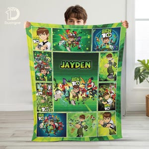 May include: A green and yellow Ben 10 themed blanket featuring various cartoon character illustrations and the name "JAYDEN" in the center. The blanket has a grid-like design with multiple panels showcasing different scenes and characters.