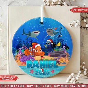 May include: A round, blue Christmas ornament featuring cartoon characters from a popular animated film. The ornament has the name "DANIEL" and the year "2025" printed on it. The ornament has a white ribbon for hanging.
