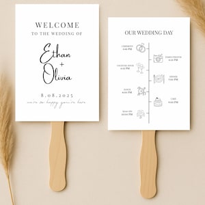 May include: Two white wedding fans with wooden handles. One fan reads "WELCOME TO THE WEDDING OF Ethan + Olivia 8.08.2025 we're so happy you're here." The other fan displays a wedding day timeline with illustrations.