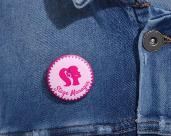 May include: Pink button with a white outline and a stylized female figure wearing headphones. The text "Stage Manager" is written in a pink cursive font.