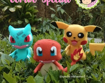 May include: A set of three felt Pokemon characters: a green and red Charmander, a yellow Pikachu, and a blue and red Bulbasaur. The characters are sitting on a bed of green leaves. The text "Combo Special" is written in pink letters above the characters.