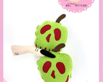 May include: A green and red felt apple with a skull design and dripping green paint. The apple is on a white background. The text "Poisoned Apple" is at the top of the image. The text "2024 by Wal Vieira" is at the bottom of the image.
