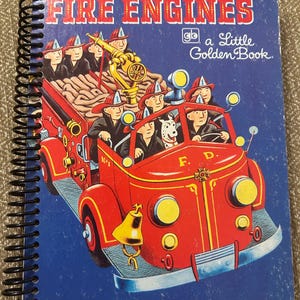 May include: A vintage children's book titled "Fire Engines" with a spiral binding. The cover features a red fire truck with firefighters and a Dalmatian dog. The text "Fire Engines" is in red letters on a blue background.