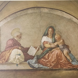 May include: A Renaissance-style fresco painting depicting a religious scene. It features three figures: an older man reading a book, a woman holding a child, and the child reaching out. The color palette includes muted tones of red, blue, and beige.