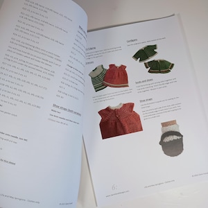 May include: An open instructional booklet titled Lilly and May Springtime featuring printed knitting patterns for doll clothing. The pages display text instructions alongside color photographs of miniature knitted dresses, cardigans, and shoes.