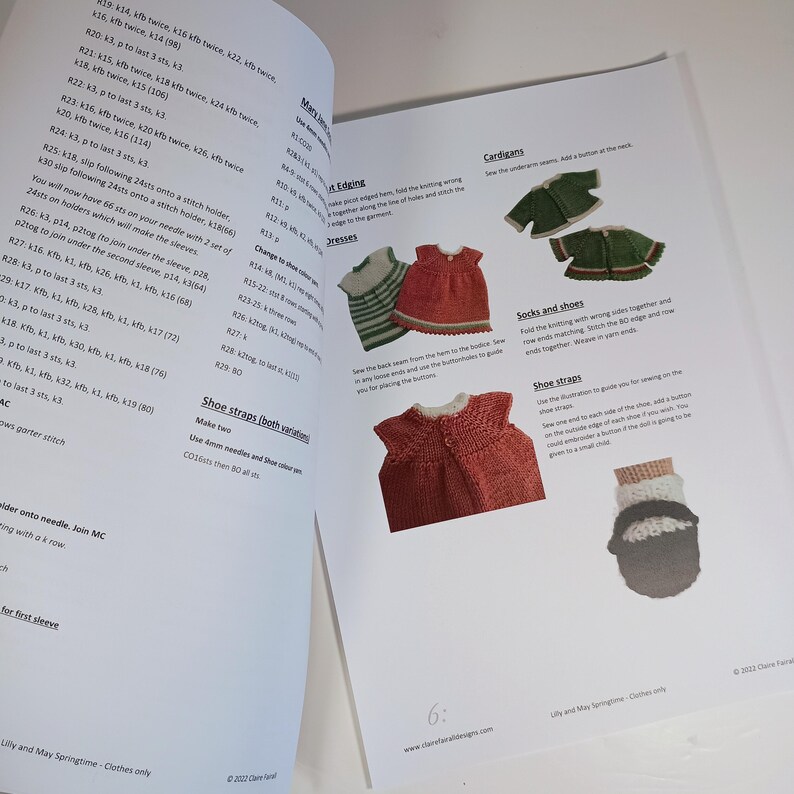May include: An open instructional booklet titled Lilly and May Springtime featuring printed knitting patterns for doll clothing. The pages display text instructions alongside color photographs of miniature knitted dresses, cardigans, and shoes.