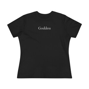 May include: Black t-shirt with the word "Goddess" printed in white, centered on the chest. The shirt has short sleeves and a crew neck. The fabric appears to be a soft, comfortable material.