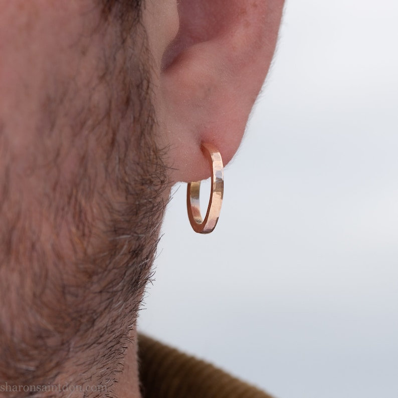 Gold hoop earrings set handmade in North America by Sharon SaintDon. Hammered solid 14k yellow gold, 18mm diameter round, 2mm wide with 14k gold posts and locking backs.