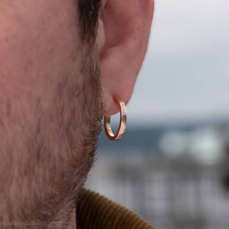 14k gold hoop earrings, 18mm diameter x 2mm . Hammered solid yellow gold with matte brushed finish. 14k gold posts and locking backs. Handmade by Sharon Saint Don in the USA.