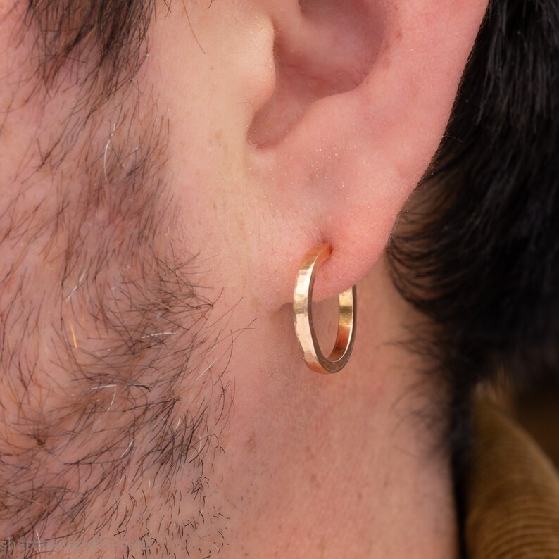 Gold hoop earrings set handmade in North America by Sharon SaintDon. Hammered solid 14k yellow gold, 18mm diameter round, 2mm wide with 14k gold posts and locking backs.