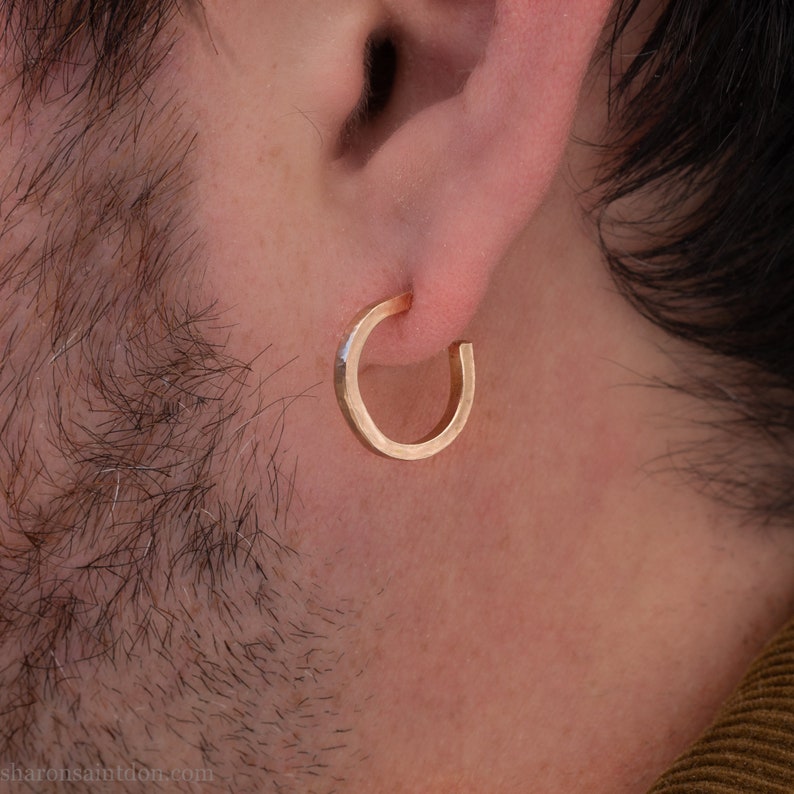 14k gold hoop earrings, 18mm diameter x 2mm . Hammered solid yellow gold with matte brushed finish. 14k gold posts and locking backs. Handmade by Sharon Saint Don in the USA.