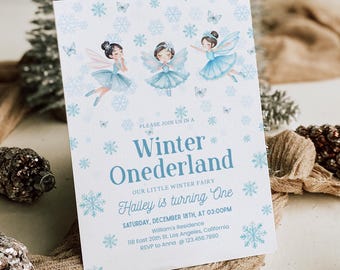 May include: A Winter Onederland party invitation featuring three fairies in blue dresses and wings. The invitation includes the text "Hailey is turning One" and event details. Decorative snowflakes and butterflies surround the text.