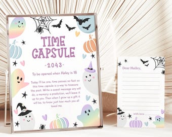 May include: A framed time capsule sign and a matching card. The sign features the text "TIME CAPSULE -2043- To be opened when Hailey is 18." The design includes ghosts, bats, pumpkins, and stars in pastel colors.