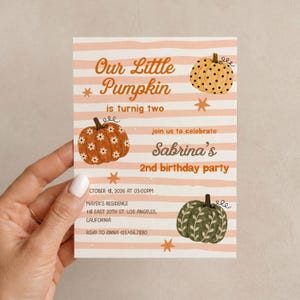 May include: A rectangular birthday party invitation card featuring horizontal peach stripes and illustrations of three pumpkins. Text reads: Our Little Pumpkin is turnig two, join us to celebrate Sabrina's 2nd birthday party, October 18, 2026 at 03:00PM.